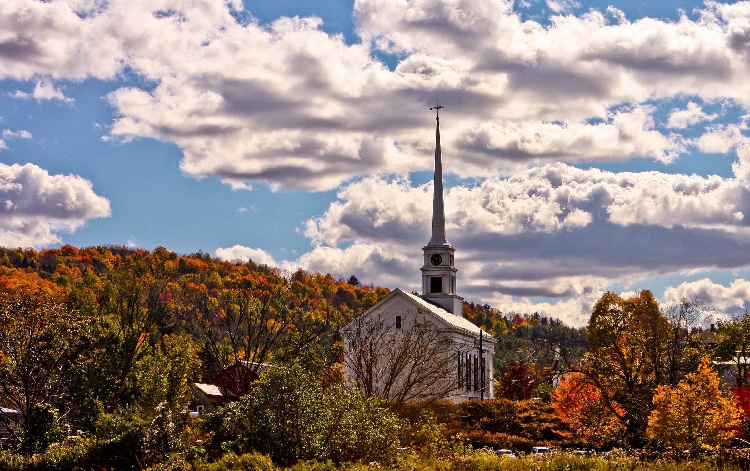 Stowe Community Church surrounded by autumn foliage in Vermont