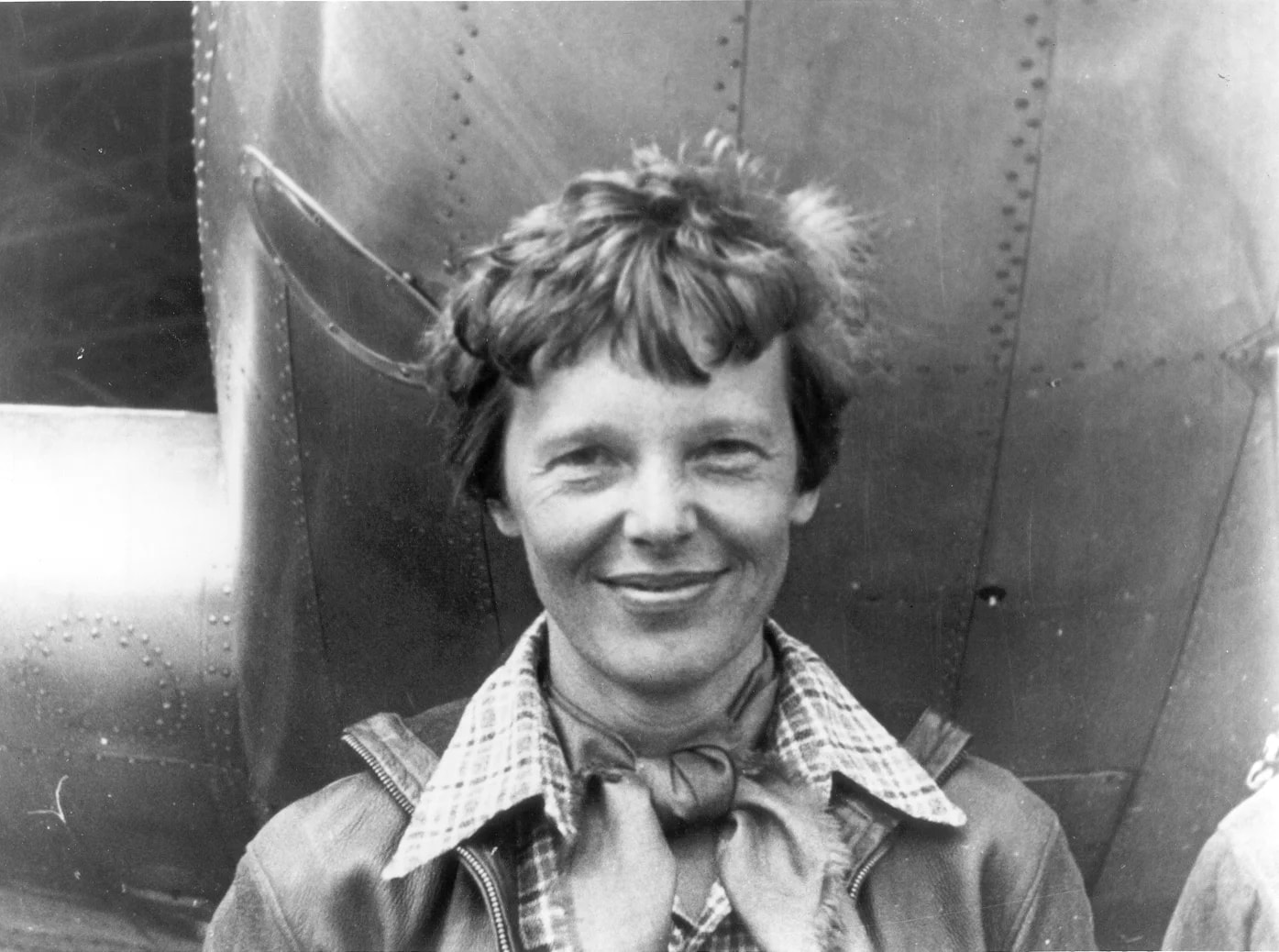 Amelia Earhart standing under nose of her Lockheed Model 10-E Electra. Gelatin silver print, 1937. National Portrait Gallery, Smithsonian Institution; gift of George R. Rinhart, in memory of Joan Rinhart