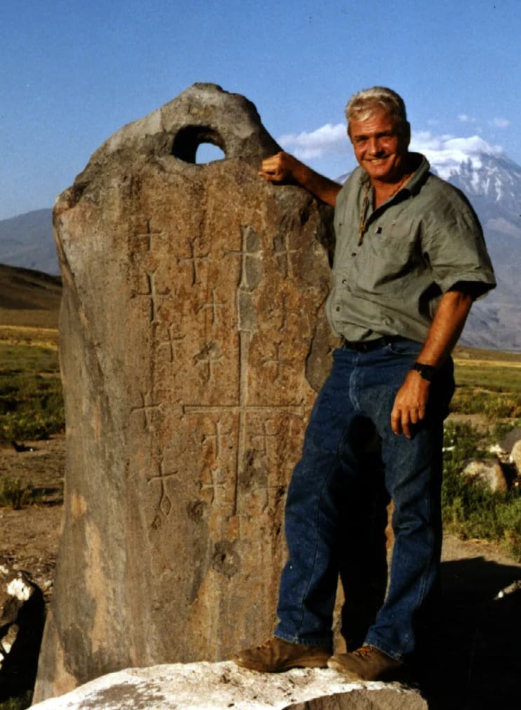 David Fasold beside a pierced stone at Arzap, now Kazan; its proposed use as an Ark anchor is unproven.